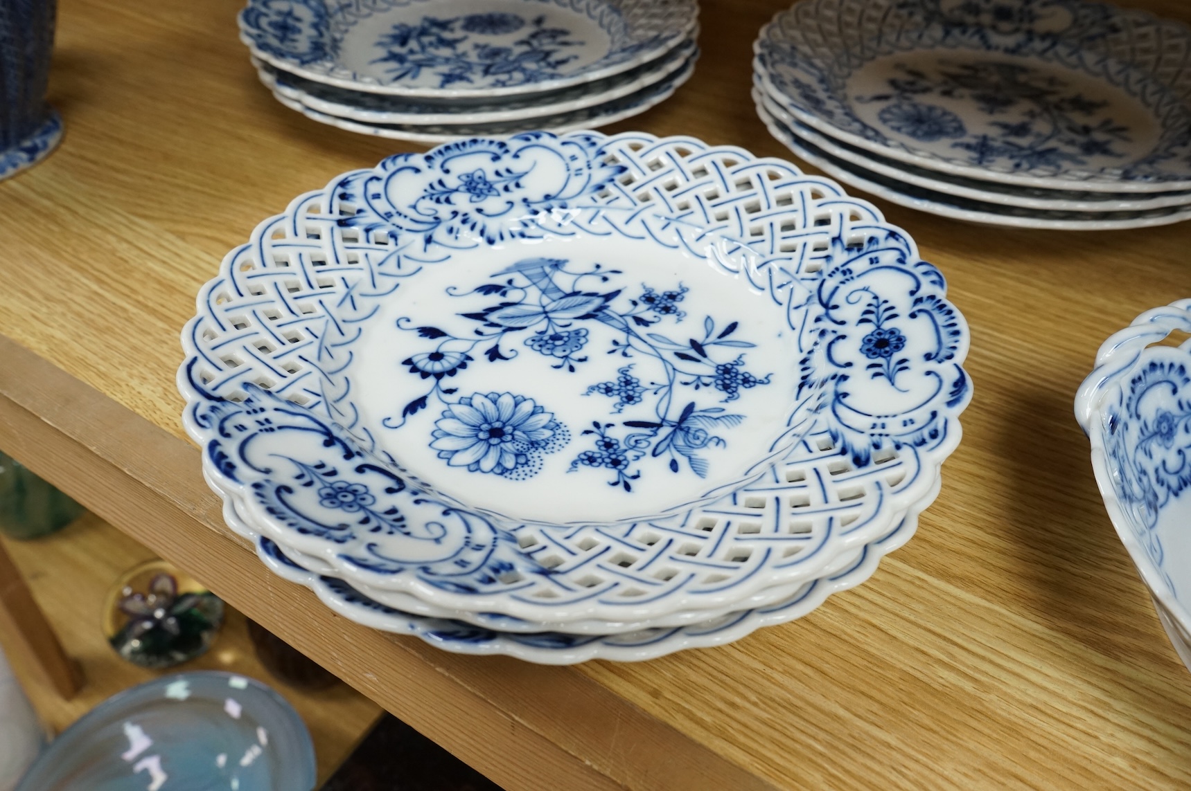 A ‘Meissen’ blue onion pattern dessert service comprising nine plates and two oval twin handled dishes, 24cm wide